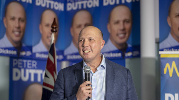 Home Affairs Minister Peter Dutton celebrates his return to the seat of Dickson while in Strathpine on election night.