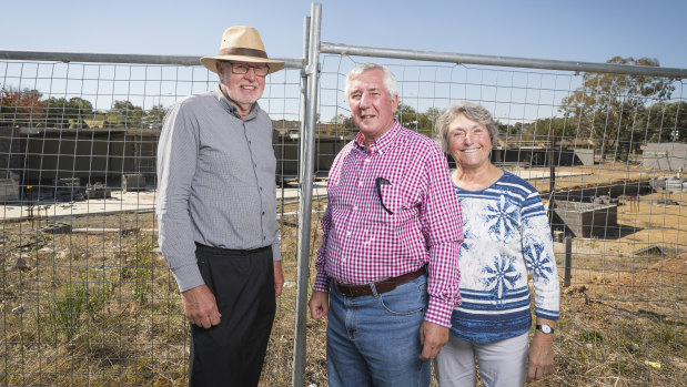 Giralang Residents Action Group members Bill Burmester and Ross and Olga Calvert, at the site of the old Giralang shops in April.