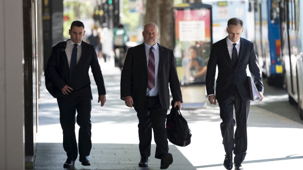 Witness Phillip Elliott (centre) arriving at ICAC for the inquiry into former MP Daryl Maguire.