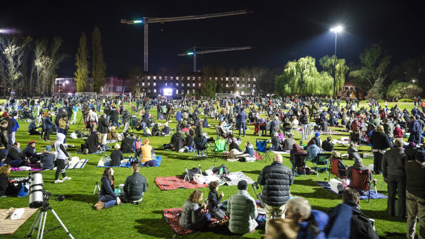 The crowd at the Australian National University's Fellows Oval begins to swell as more people arrive for an attempt to break the Guinness World Record for the most people simultaneously stargazing at multiple venues.