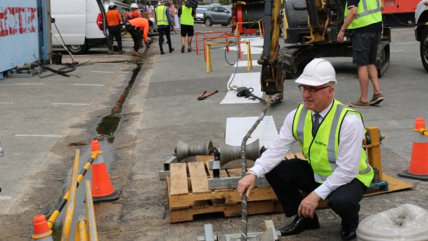 Sunshine Coast Mayor Mark Jamieson watches as the fibre-optic telecommunications cable is prepared to link Queensland with Asia.