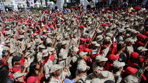 Members of Venezuela's Bolivarian militia cheer for Nicolas Maduro in Caracas.