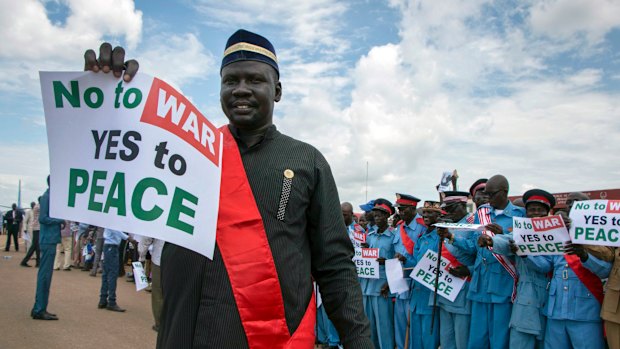 South Sudanese people hold signs as talks to end the five-year civil war were under way.