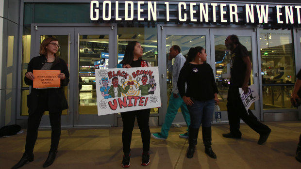 Demonstrators protesting the shooting death of Stephon Clark by Sacramento Police officers block the entrance to a Sacramento NBA game.