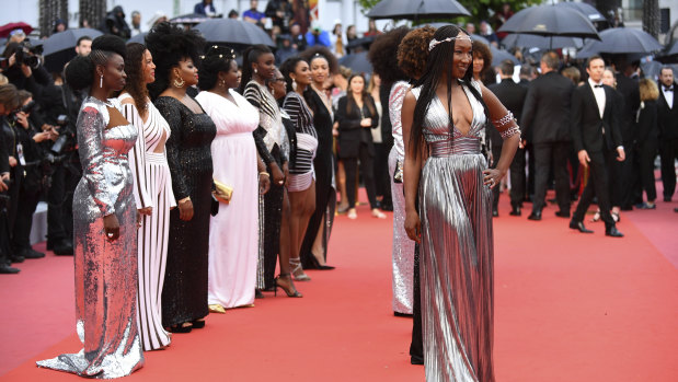 Authors of the book 'Black is not my job' pose for photographers upon arrival at the Cannes Film Festival red carpet.