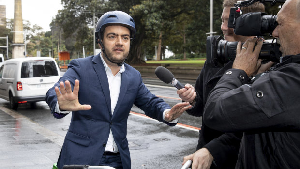 Sam Dastyari arrives on a Lime bike to give evidence at the inquiry into alleged illegal donations to the Labor Party.