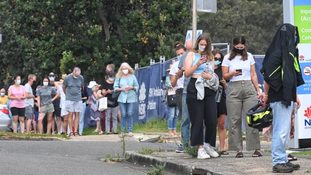 People line up for a COVID-19 test in Sydney. Even a localised outbreak could hurt the recently updated federal budget.
