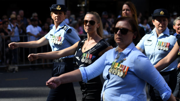 Members of By The Left are seen marching through Brisbane during Anzac Day commemorations.