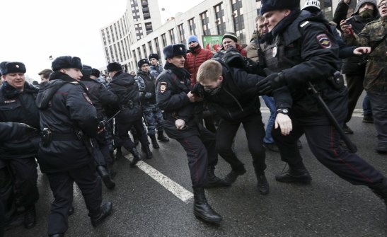 Police officers detain a demonstrator at the Free Internet rally in Moscow on Sunday.