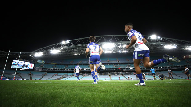 Bulldogs players run out on Thursday night for the first NRL game to be played in an empty stadium.