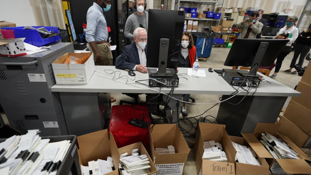 Democratic and Republican representatives review absentee ballots at the Fulton County election centre. 