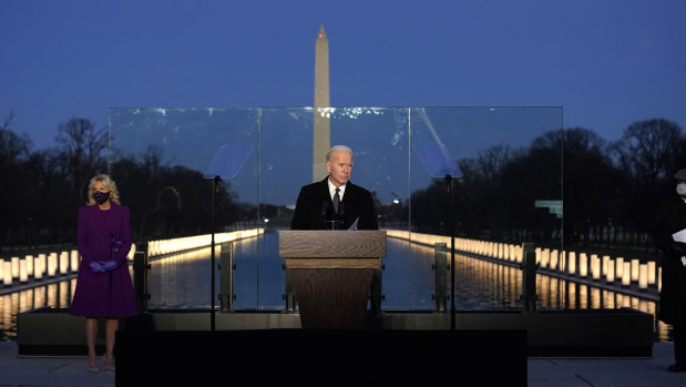 President-elect Joe Biden speaks during a COVID-19 memorial, with lights placed around the Lincoln Memorial Reflecting Pool. 