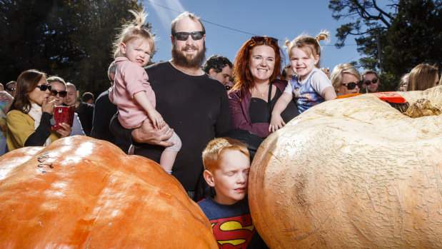 Goulburn residents Biam and Louise Mooney and their children Addison, 2, Xander, 6, and Nora, 3, check out the 271kg winning pumpkin at the Collector Village Pumpkin Festival.