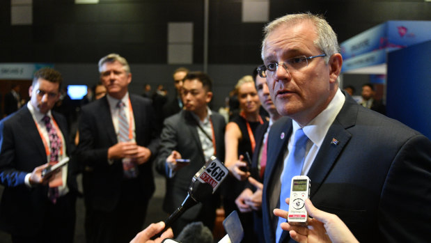 Prime Minister Scott Morrison speaks to journalists at the Singapore summit. 
