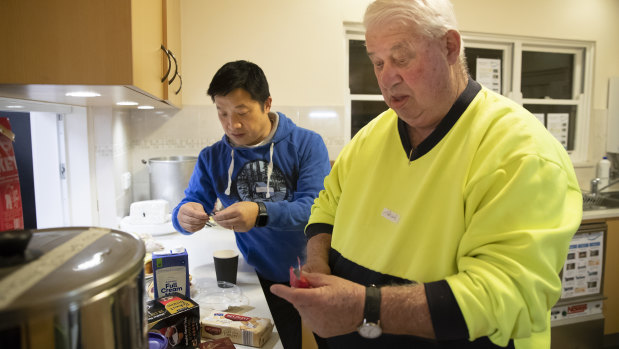 Safe Shelter volunteers  David Chang and Trevor Gilbert prepare refreshments at All Saints Church, Ainslie. 