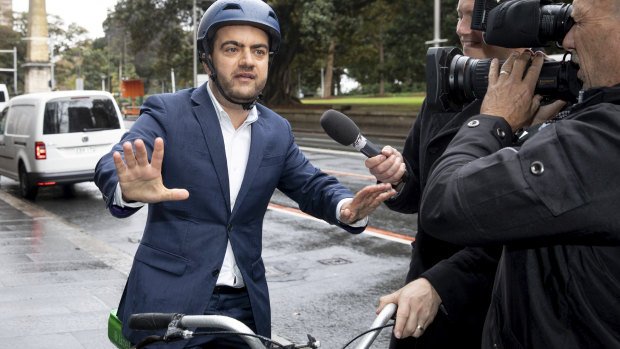 Sam Dastyari arrives on a lime bike to give evidence at the ICAC inquiry into alleged illegal donations to the Labor Party.