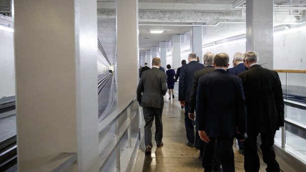 US senators are escorted by US Capitol police through tunnels to a safe location after Trump supporters breached the US Capitol last week.