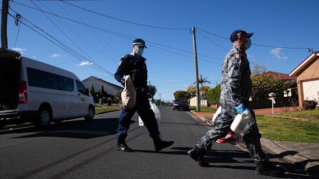 Police and ADF officers deliver groceries to people in isolation in the Fairfield LGA during Sydney’s lockdown.