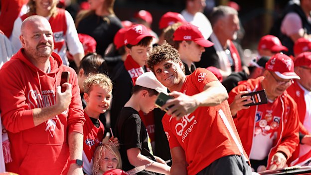 Charlie Curnow poses for selfies with Swans fans on Thursday.