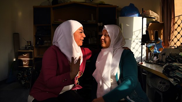 Lara Shaheen, 36, (left) talks with her mother, Hasna’a al-Beesh, 56, in the sewing room at Jasmine Foundation in Irbid, Jordan.