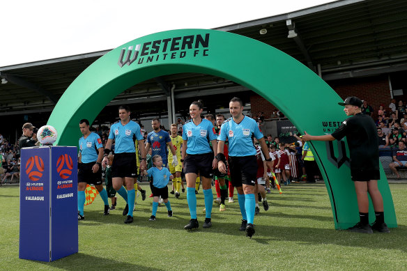The referees lead out the teams for Western United's recent match in Ballarat against Wellington.
