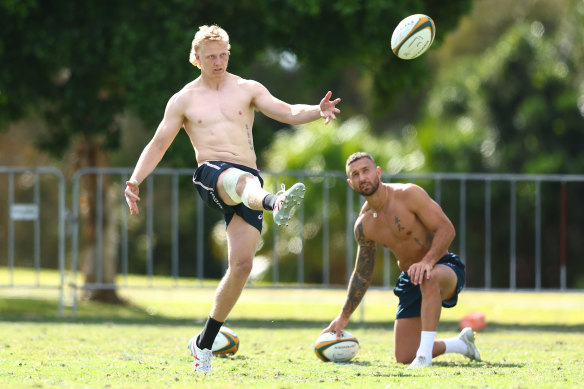 Carter Gordon kicking with Quade Cooper assisting.