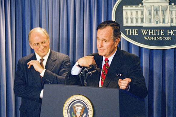 Cheney watches as President George HW Bush holds a press conference at the White House in 1989.