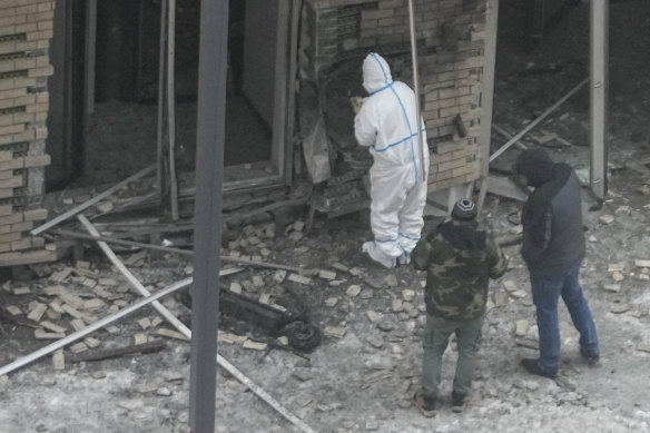 Investigators work near a scooter at the place where Igor Kirillov and his assistant were killed by an explosive device.