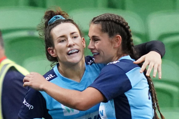 Maya Stewart is congratulated by Waratahs teammates after scoring a try at AAMI Park on Friday.