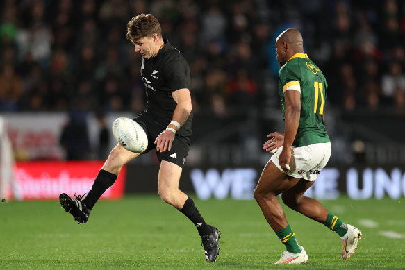 Beauden Barrett puts in a kick. 