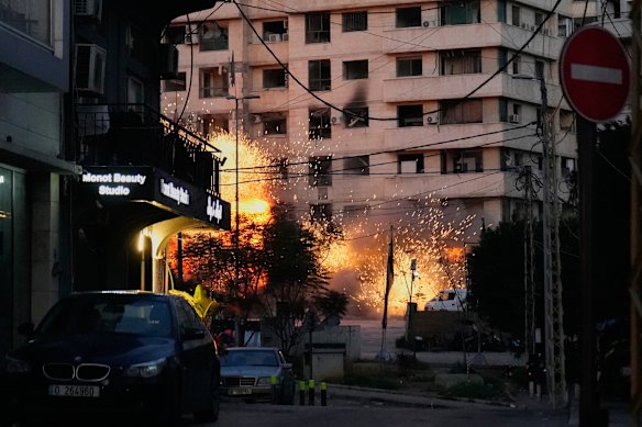 An explosion erupts from a building following an Israeli strike in central Beirut, Lebanon.
