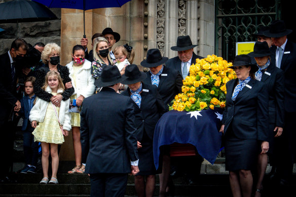 Bert Newton’s widow Patti and daughter Lauren look on as the TV icon’s casket leaves St Patrick’s Cathedral. 