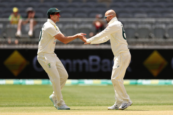 Nathan Lyon and Pat Cummins celebrate.