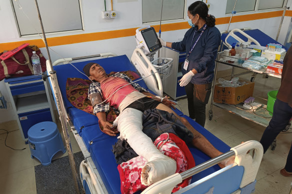 A man is treated in hospital in Nepalgunj, Nepal. Helicopters and ground troops rushed to help people hurt in a strong earthquake that shook north-western Nepal districts as people slept.