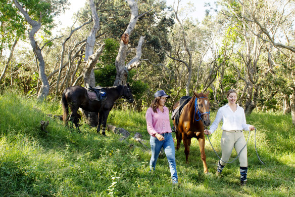 Priscilla Balshaw and Matilda Winchester get the horses ready for tourists to ride on Seven Mile Beach in Lennox Head.