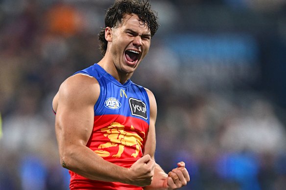 Cam Rayner of the Lions celebrates kicking a goal.