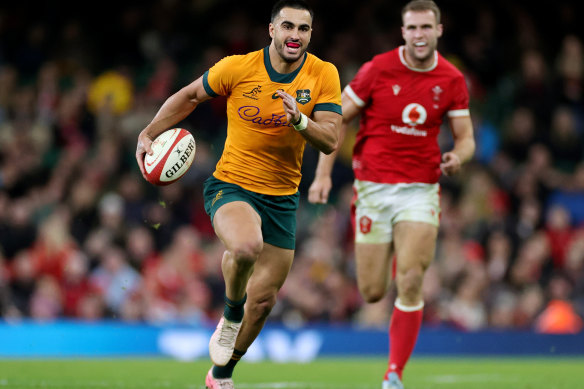 Tom Wright breaks through to score his third try in Cardiff.