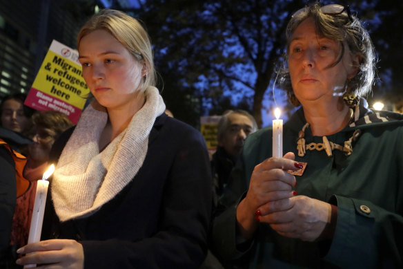 Demonstrators hold banners and candles during a vigil for the 39 lorry victims, outside the Home Office in London on Thursday.