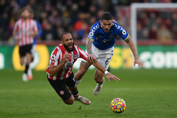 Brentford’s Bryan Mbeumo is fouled by Allan of Everton.