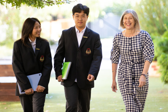 Camberwell High School international students Meilee Rianrukwong and Ryan Shan with principal Jillian Laughlin.