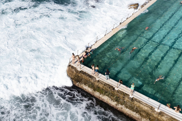 People take advantage of the winter sunshine at Bondi Icebergs in Sydney. 