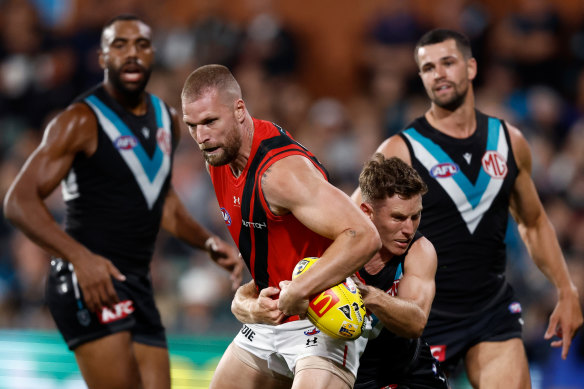 Jake Stringer of the Bombers is tackled by Kane Farrell of the Power.