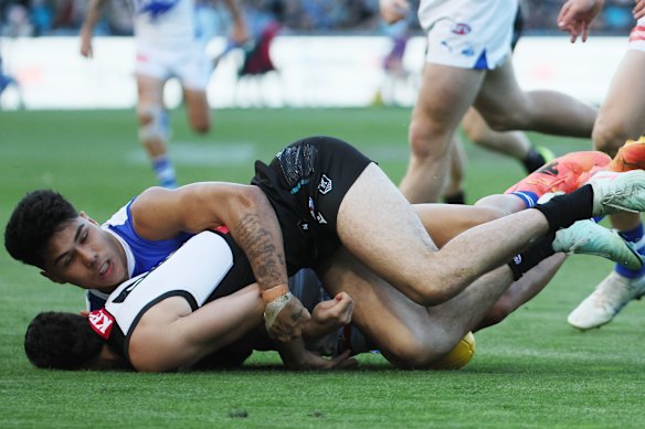 Concussed: Josh Sinn is tackled by Paul Curtis of the Kangaroos.