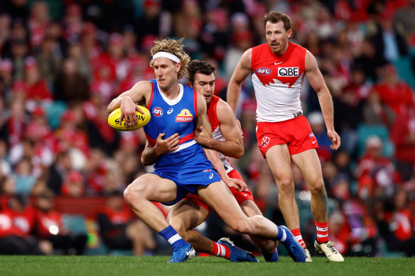 Aaron Naughton of the Bulldogs is tackled by Logan McDonald of the Swans at the SCG.