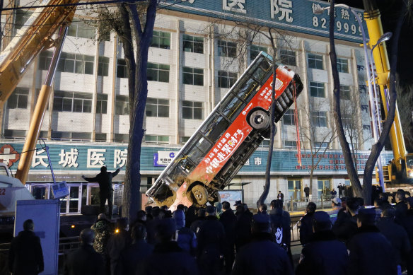 A crane was called in to lift the bus out of the sinkhole.