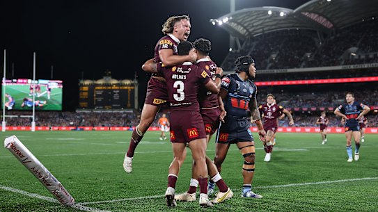 Maroons players celebrate one of Selwyn Cobbo’s two tries in Adelaide.