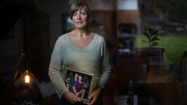 Shelley Anson took part in a washing and dressing ritual when her mother Lorraine died. Here, she holds a frame photo of her parents.