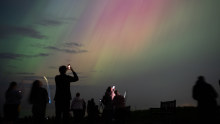 People visit St Mary’s lighthouse in Whitley Bay to see the aurora borealis, commonly known as the northern lights, on May 10, 2024, in the UK.