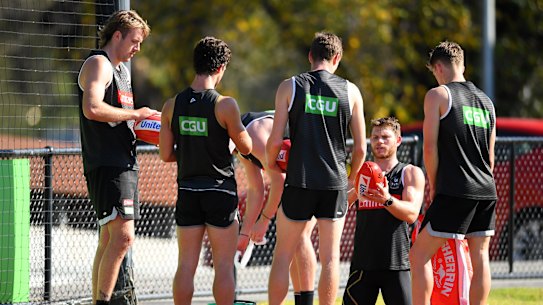 Taylor Adams wipes down the footballs during Collingwood's training session at the Holden Centre.