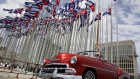 A classic American convertible car passes the United States embassy in Havana.